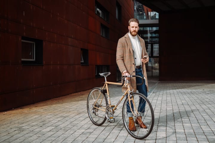 Urban Elegance: A Businessman With A Bicycle In Autumn