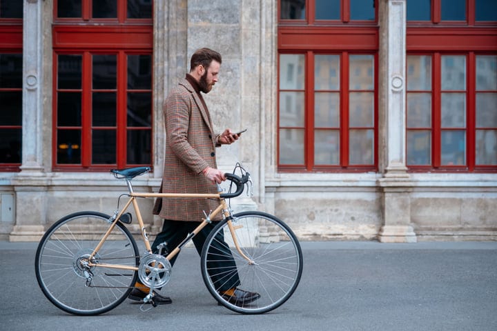 Stylish Businessman Navigates Urban Streets With Bicycle