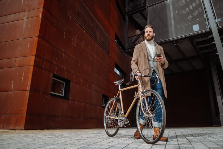 Confident Businessman Navigates Urban Streets With Bicycle