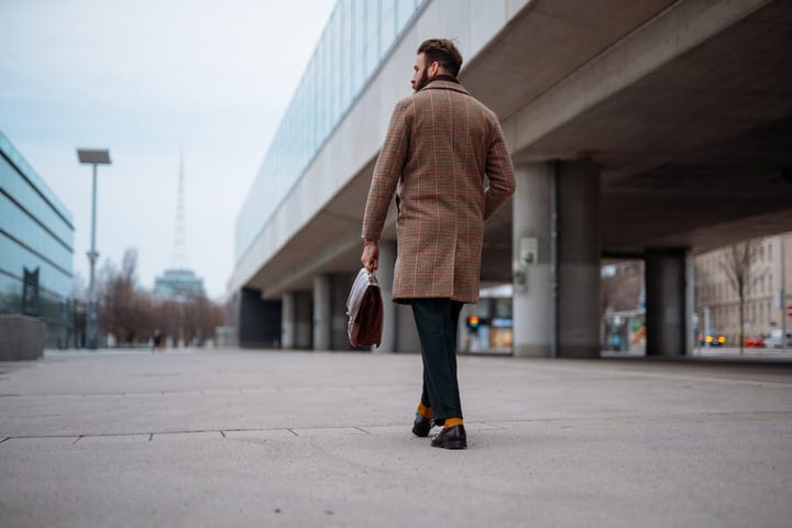 Businessman Strides Confidently Through Urban Landscape