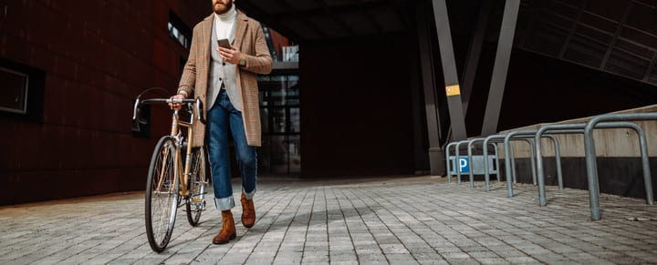 Businessman Strolls With Bicycle On Urban Pathway