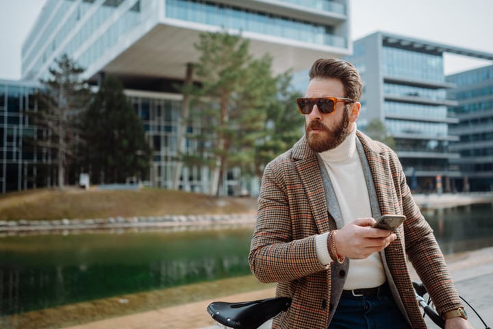 Bearded Businessman Navigates His Urban Morning on a Bike