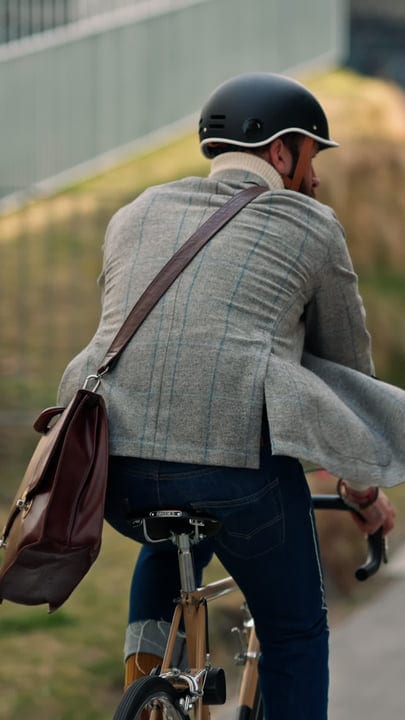 Businessman Pedals Through Urban Streets On Bicycle Commute