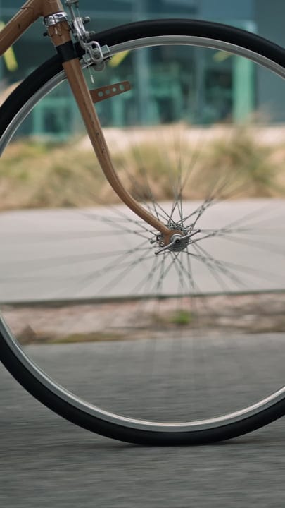A Bicycle Wheel Spins Through The City Streets