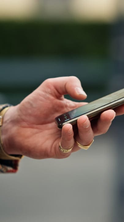 Checking Messages On The Go: A Businessman's Routine