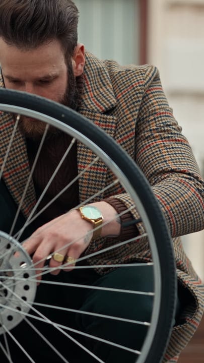 Businessman Adjusts Bicycle Wheel During Urban Commute