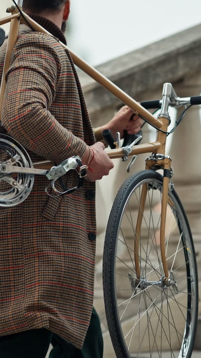 Businessman Carries Bicycle Through Urban Landscape With Purpose