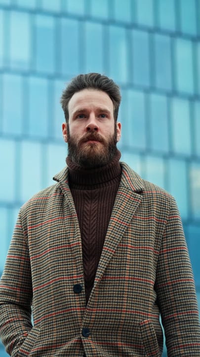 Confident Businessman in Tweed Coat Faces Urban Challenges