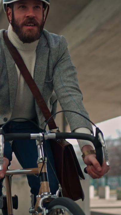 Businessman Pedals Through Urban Streets On Bicycle