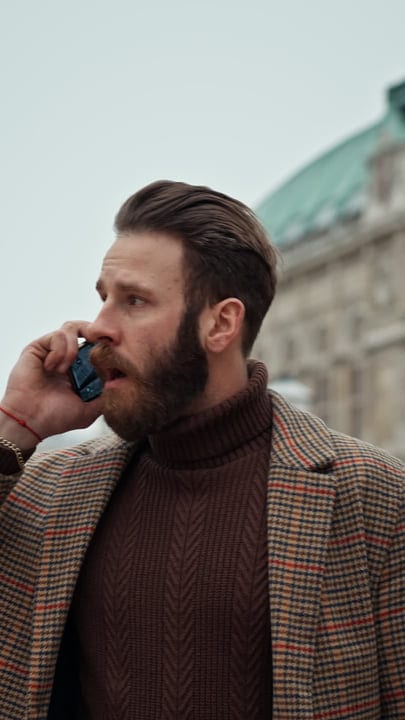 Focused Businessman Engages in Urban Street Call