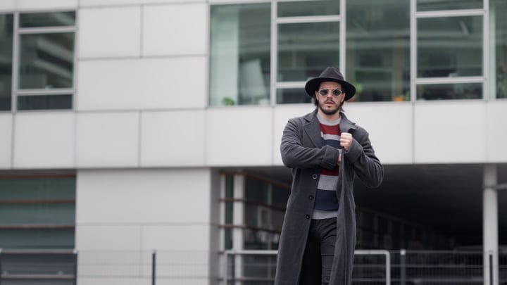 Confident Businessman Walks Through Modern Cityscape