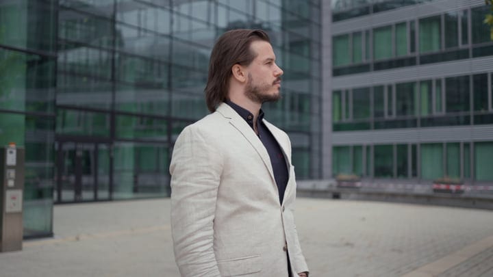Confident Businessman Strolling Past Modern Architecture