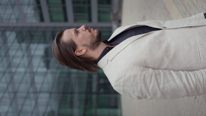 Confident Businessman Strolling Through Urban Glass Jungle