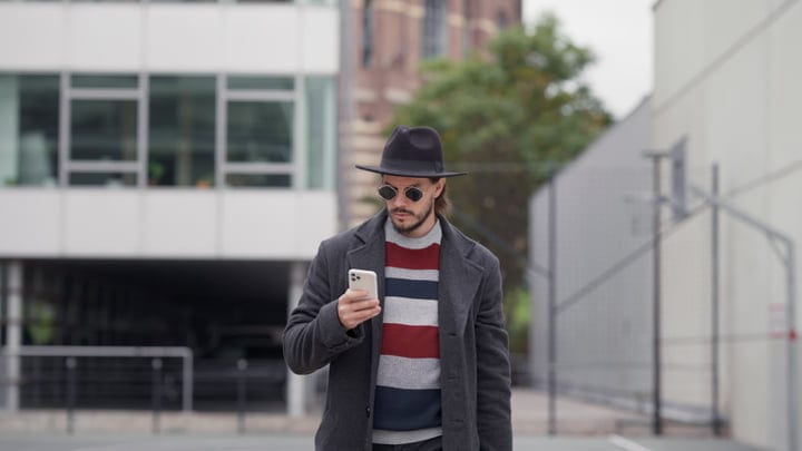 Urban Elegance: Businessman Engaged with Smartphone
