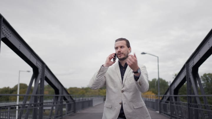 Businessman Navigates Urban Bridge On A Crisp Day