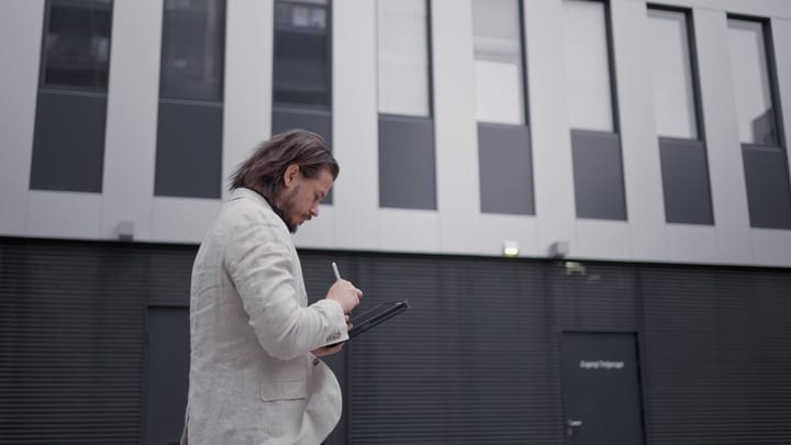 Businessman Engages With His Tablet During Urban Stroll