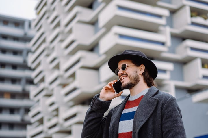 Chic Businessman Chats Amidst Urban Architecture