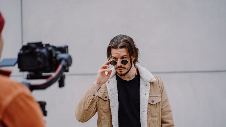 Confident Businessman Adjusts Sunglasses During Urban Shoot
