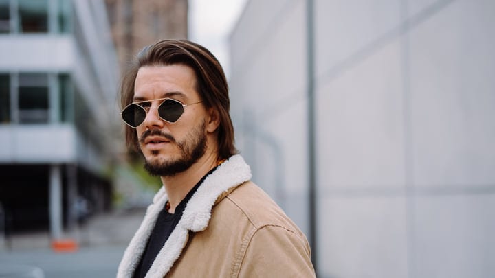 Confident Businessman Strolling Through Urban Streets In Autumn