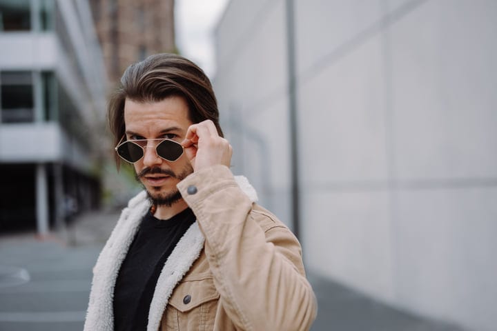 Casual Elegance As Businessman Adjusts Sunglasses