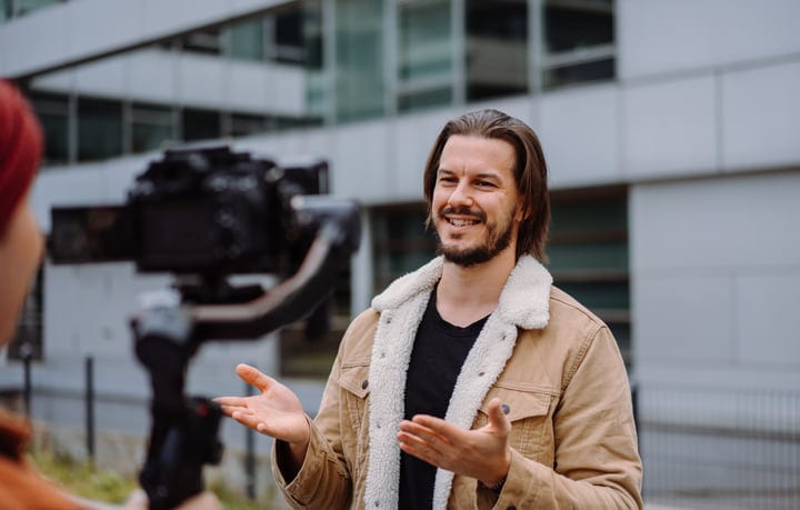 Confident Businessman Engages With Camera During Urban Stroll