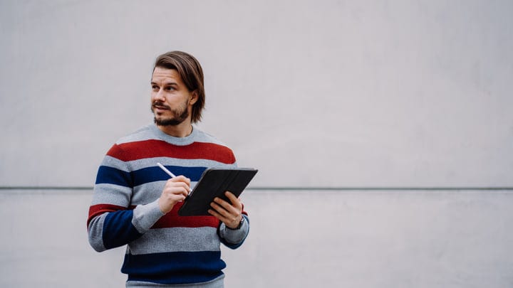 Businessman Ponders Ideas During Urban Tablet Session