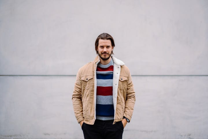 Confident Businessman Embraces Fall in Urban Setting