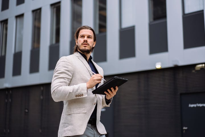 Dynamic Urban Stroll With Tablet In Hand