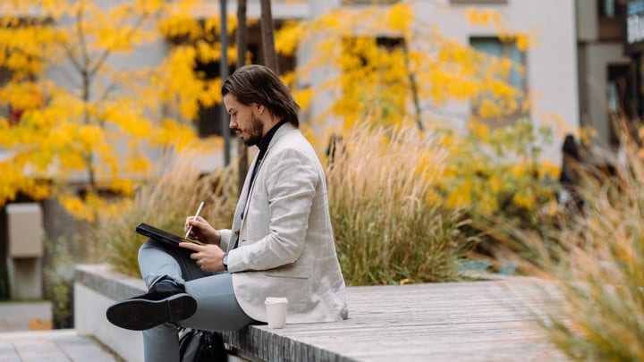 Focused Businessman Engages With Digital Tablet Outdoors