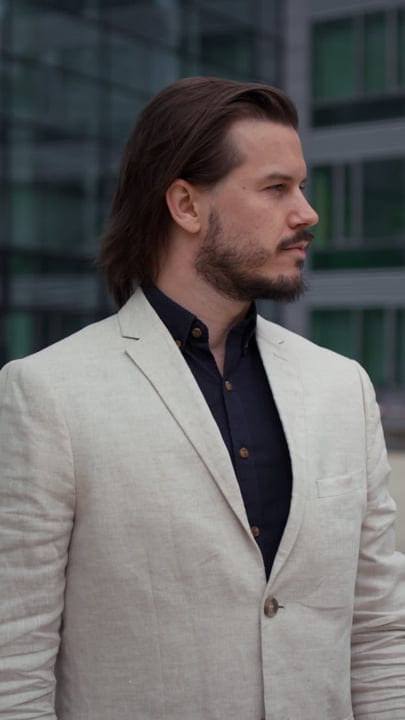 Confident Businessman in Cream Blazer Gazing at Skyline