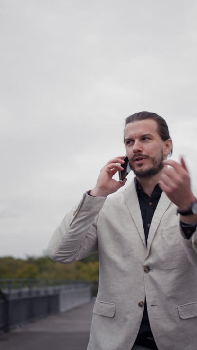 Confident Businessman Engaged in Outdoor Phone Conversation