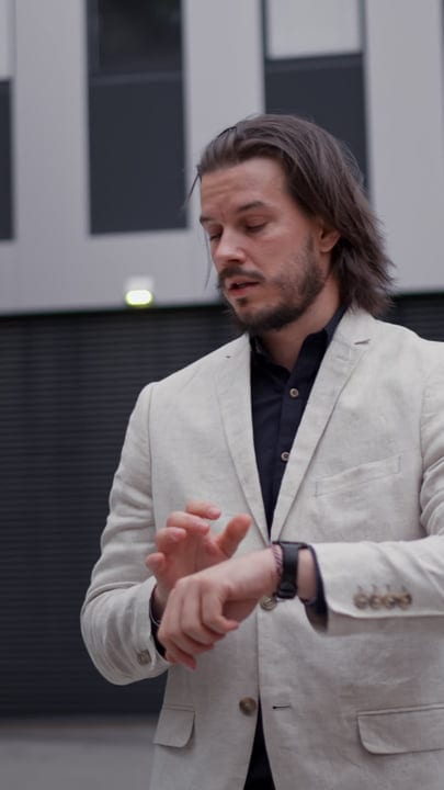A Businessman's Thoughtful Pause In The Urban Landscape