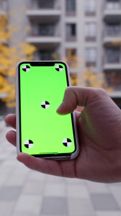 Checking A Smartphone In The Heart Of Autumn City